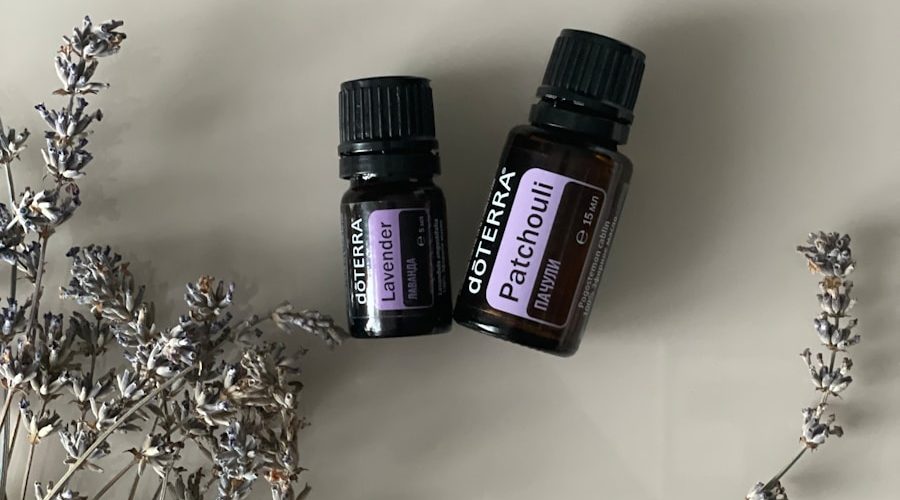 two bottles of essential oils sitting next to a plant