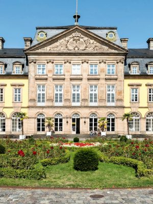 a large building with a circular garden in front of it